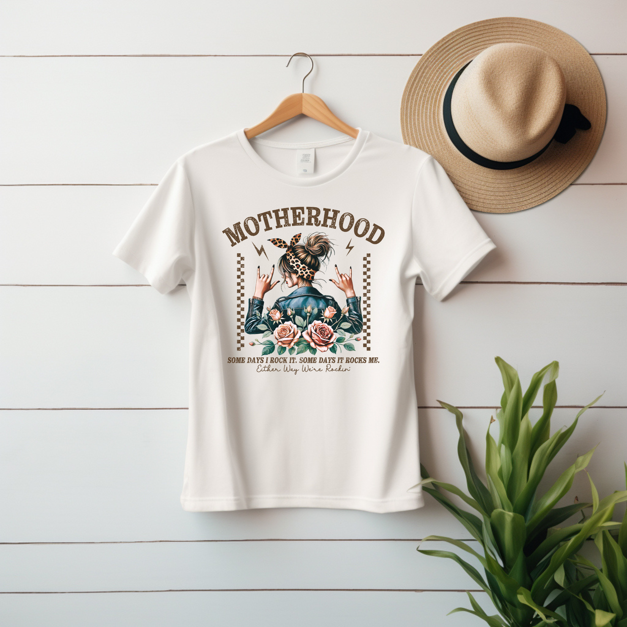 “Motherhood – Some Days I Rock It, Some Days It Rocks Me” Unisex Graphic Tee product thumbnail image