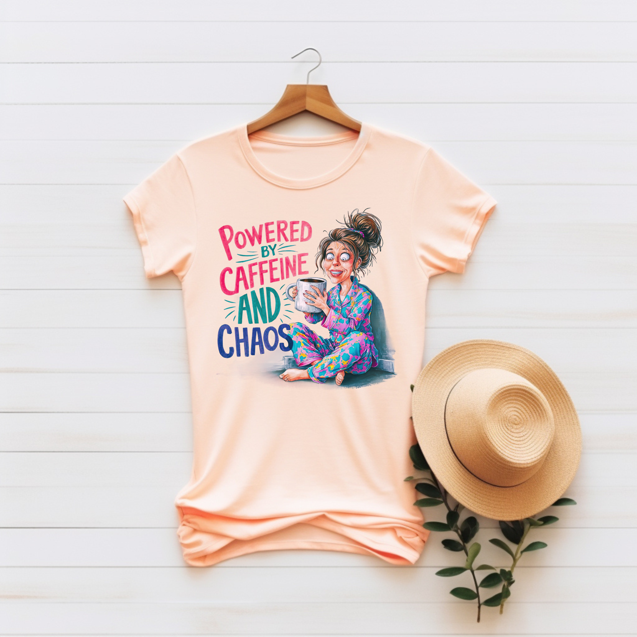 “Powered by Caffeine and Chaos” Unisex Graphic Tee product thumbnail image “Powered by Caffeine and Chaos” Unisex Graphic Tee product thumbnail image