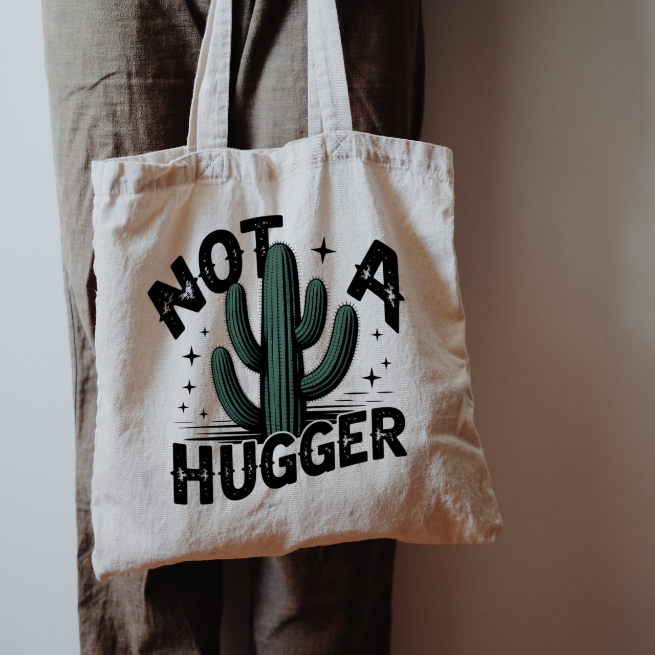 Not a Hugger Canvas Tote Bag By Sharp Tongue Studio product thumbnail image Not a Hugger Canvas Tote Bag By Sharp Tongue Studio product thumbnail image