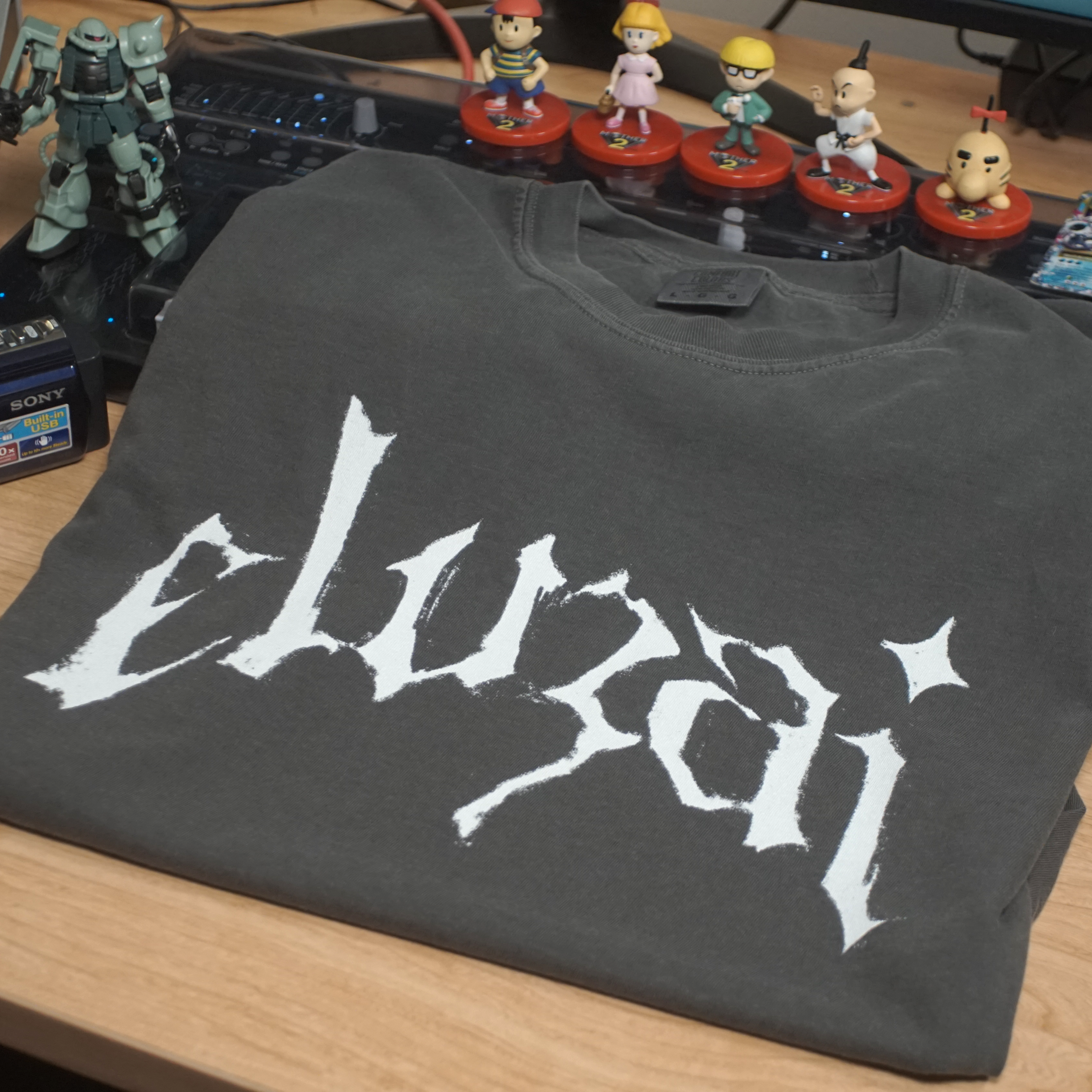 Eluzai Shirt (Ancient) product thumbnail image Eluzai Shirt (Ancient) product thumbnail image