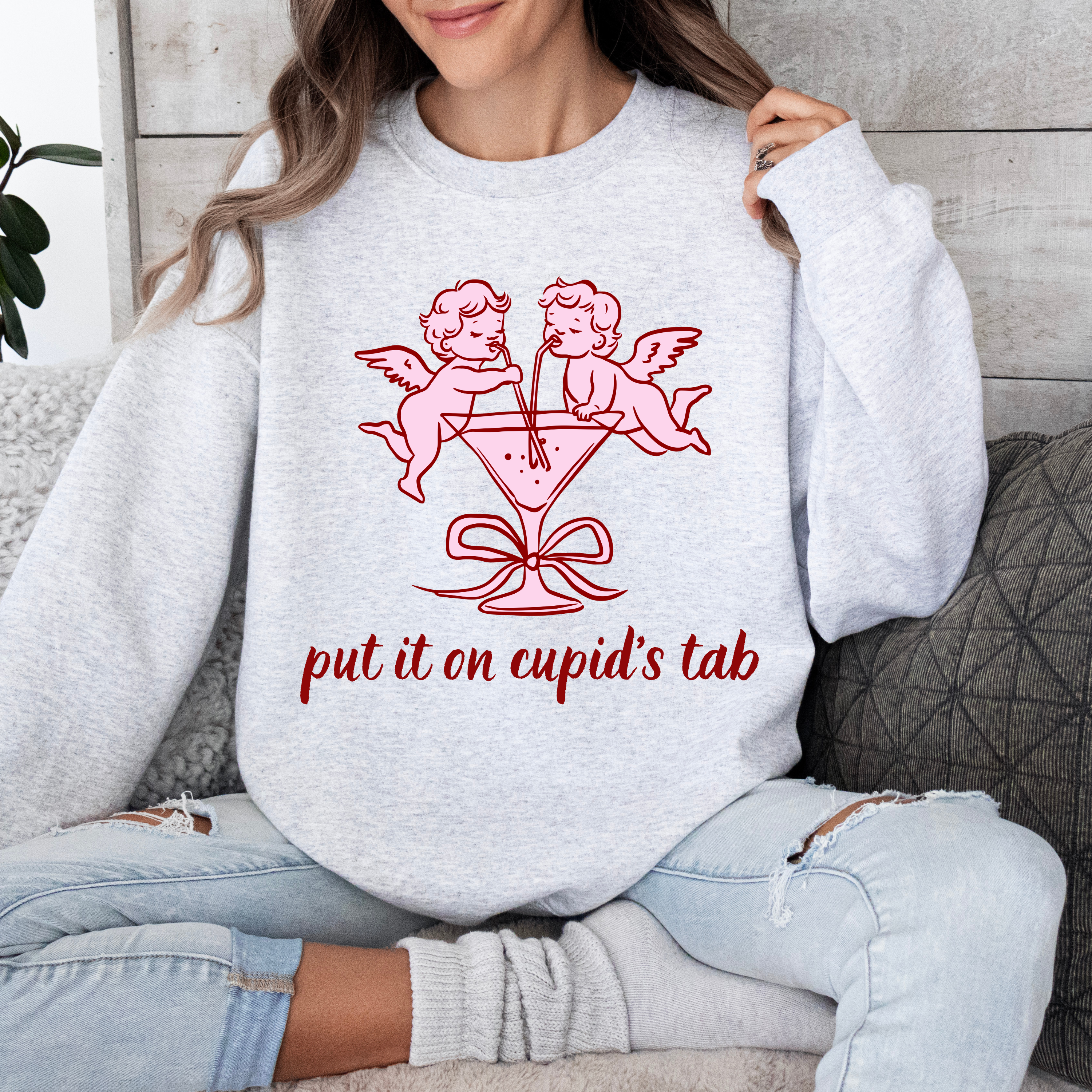 Valentine Sweatshirt — 'Put it on Cupid's Tab' Cherub Graphic Crewneck product thumbnail image Valentine Sweatshirt — 'Put it on Cupid's Tab' Cherub Graphic Crewneck product thumbnail image
