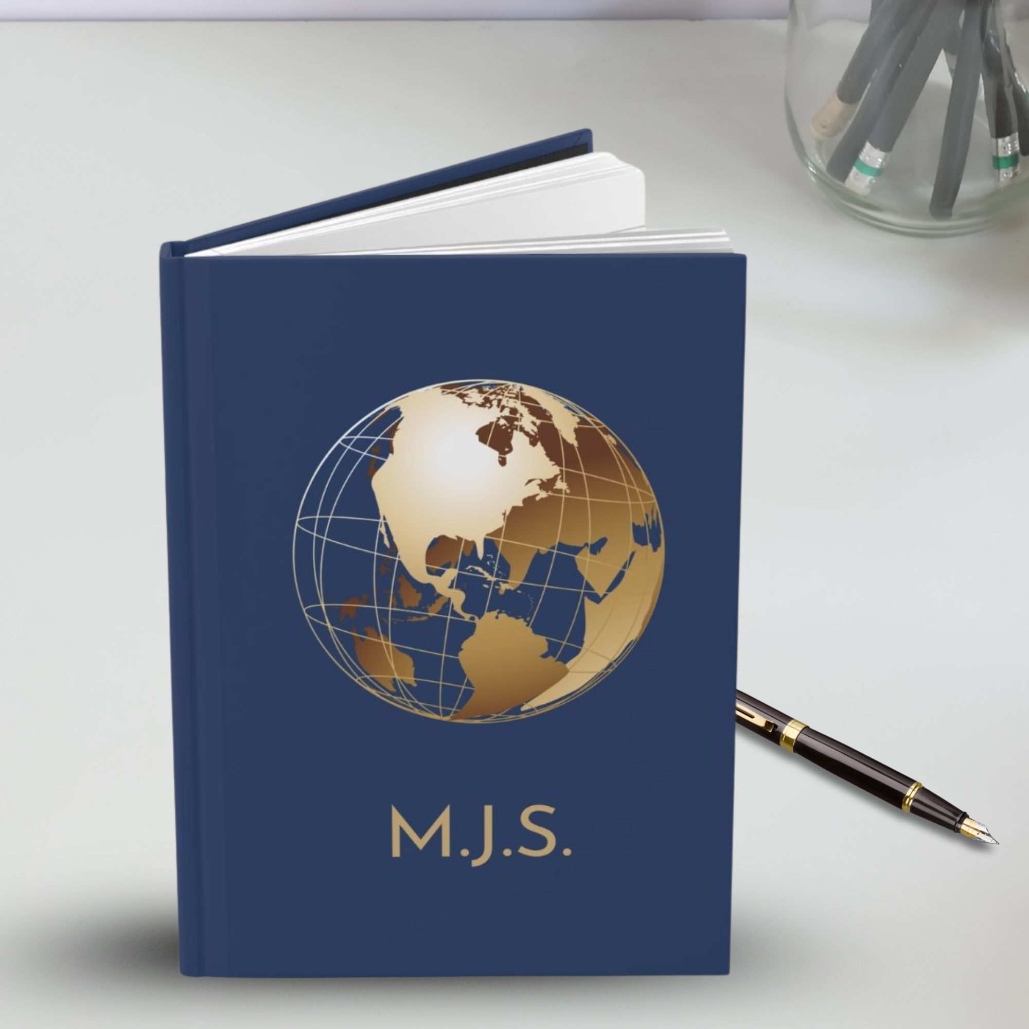 Personalized classic travel journal in dark blue with custom name and globe motif product thumbnail image