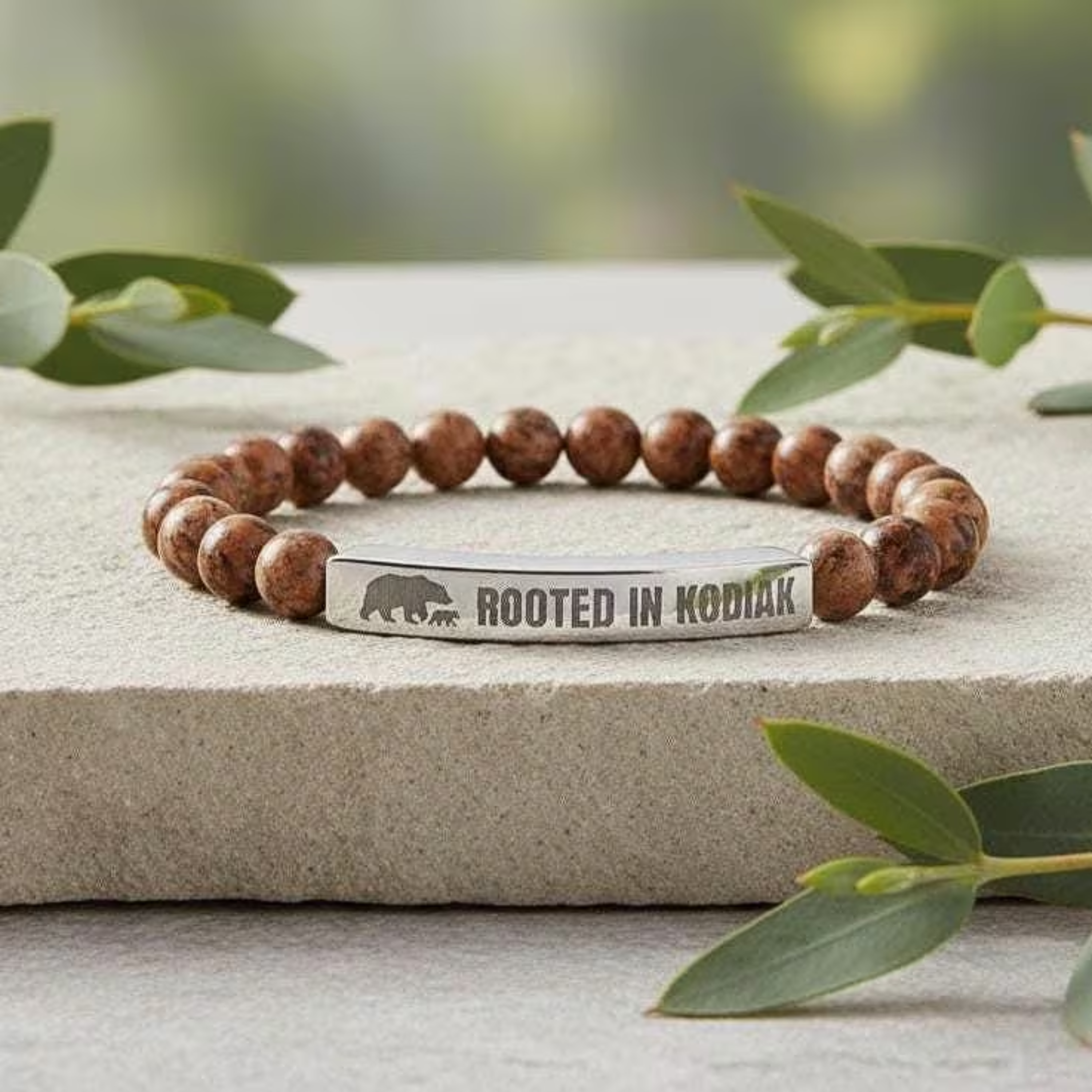 Engraved "Rooted in Kodiak" Natural Stone Stretch Bar Bracelet product thumbnail image Engraved "Rooted in Kodiak" Natural Stone Stretch Bar Bracelet product thumbnail image