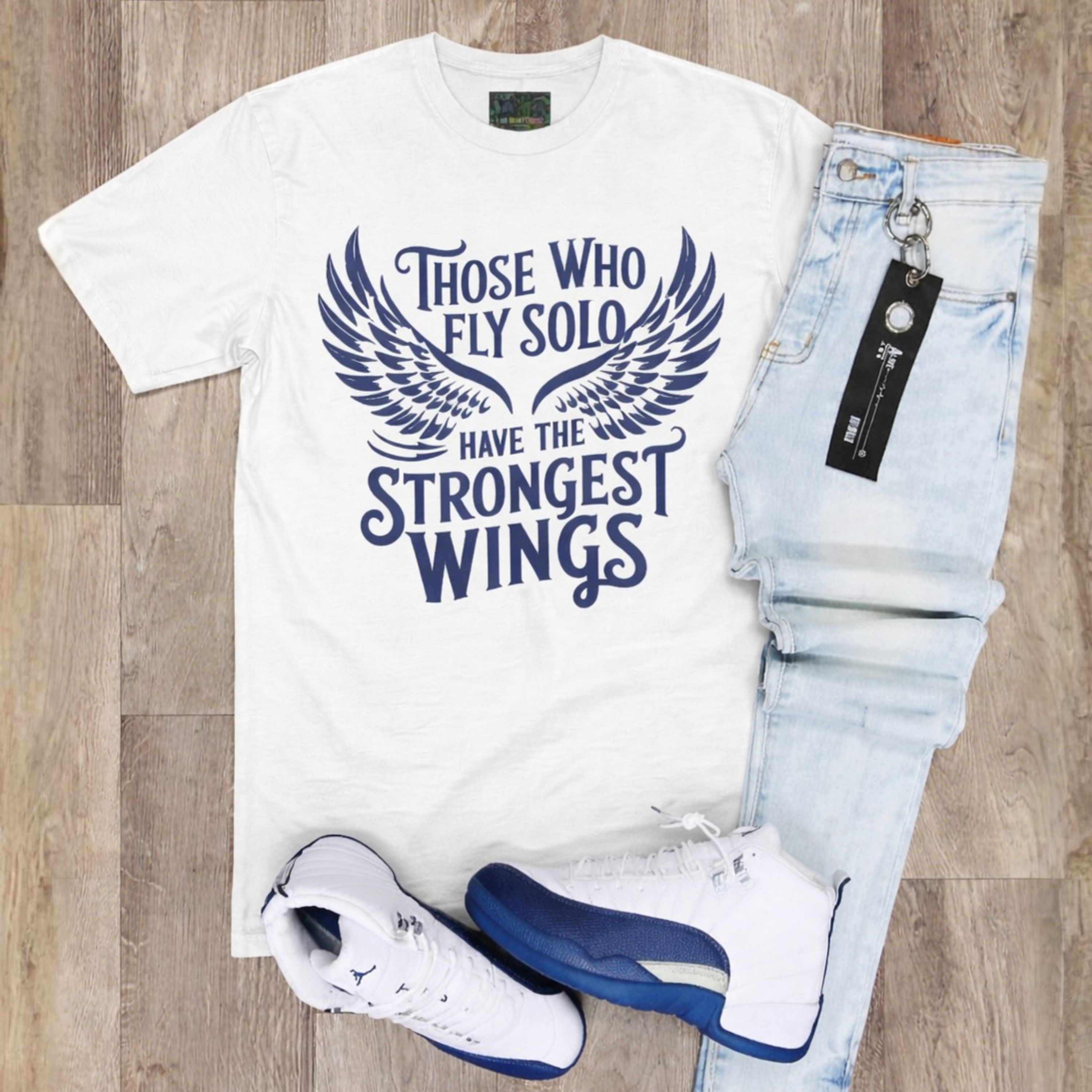  Unisex "Those Who Fly Solo Have The Strongest Wings" Diffused Blue/White Staple Tee.