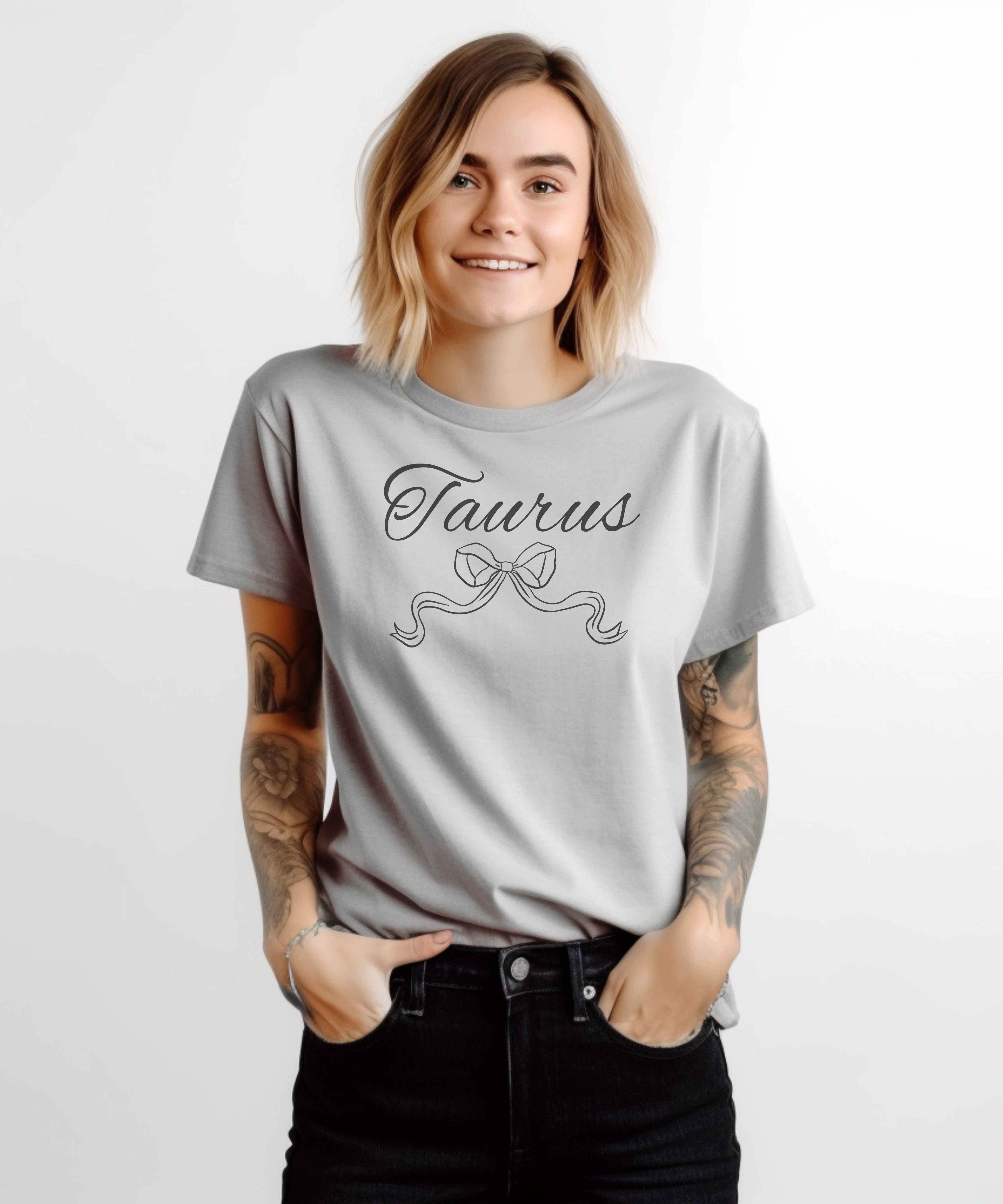 Taurus Script Zodiac Tee Elegant Bow Astrology T‑Shirt product thumbnail image Taurus Script Zodiac Tee Elegant Bow Astrology T‑Shirt product thumbnail image